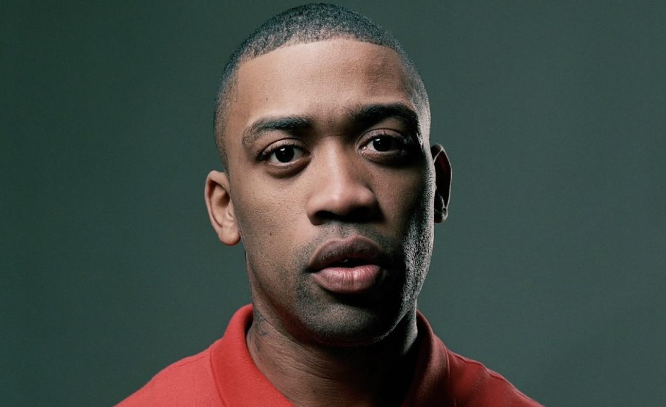 Grime star Wiley poses in a red T-shirt