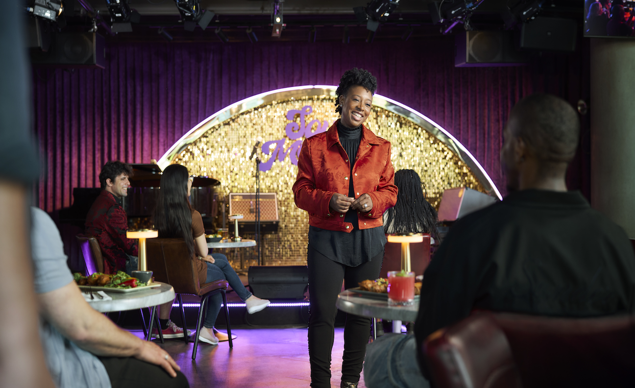 YolanDA Brown poses in a red jacket at a Soul Mama event