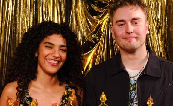 Olivia Dean and Sam Fender pose with their BRIT Award 2026 for Rein Me In