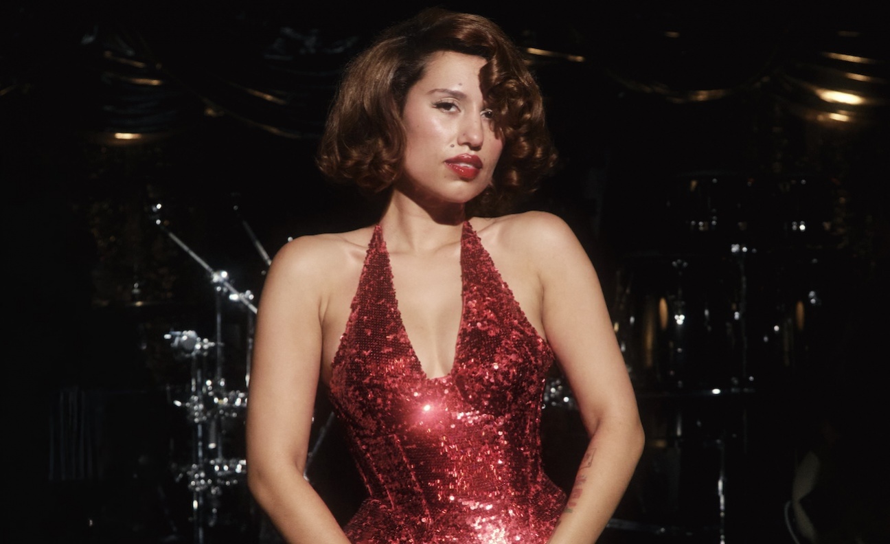Raye in a red dress