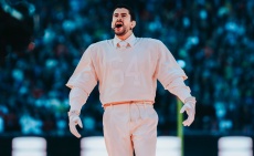 Bad Bunny wears a salmon pink American Football shirt while performing the Super Bowl half time show