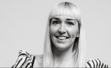 Chloe Uppington poses in a black-and-white headshot wearing a stripy top