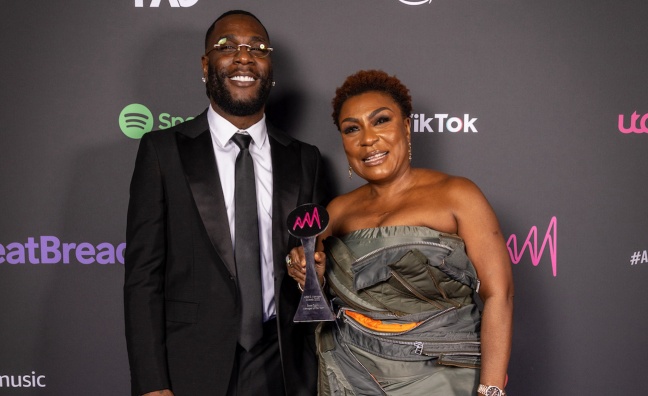 Burna Boy celebrates with his triumphant manager (and mother) Bose Ogulu at 2022 Artist & Manager Awards